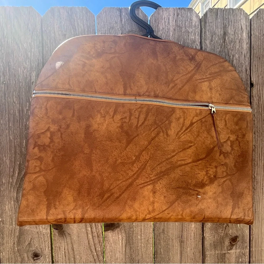Vintage leather carry on for hanging clothes.